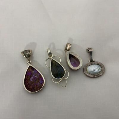 .69. Four Sterling Pendants | Various Stones