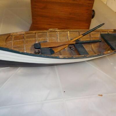 Vintage coffee grinder and wood boat model.