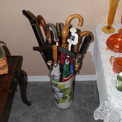 Umbrella stand, full of umbrellas and canes 