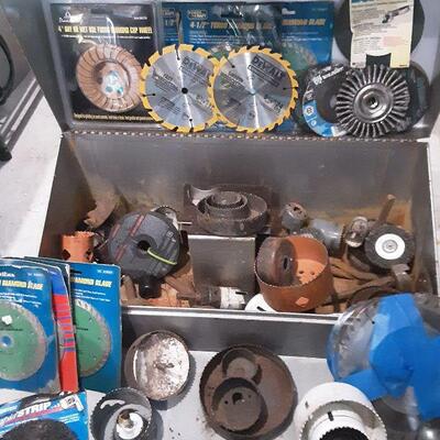 LOT 84 - Heavy metal toolbox of saws, attachments, etc