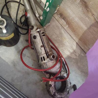 lot 114 -Ridgid 700 pipe threading machine, ladder, submersible 1/3hp pump, pipe wrench, chain wrench, puller in bucket, etc