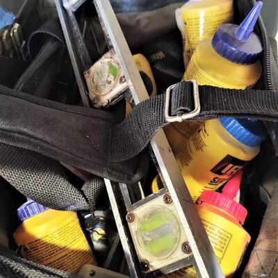 lot 124 - Canvas tool bag of asstd levels, squares, measuring angles, strait line dust, micrometer, plumb lines, measuring tapes, etc