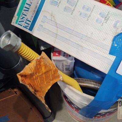 lot 128 -Bucket of assorted plumbing tubing, water heater installation kit etc.