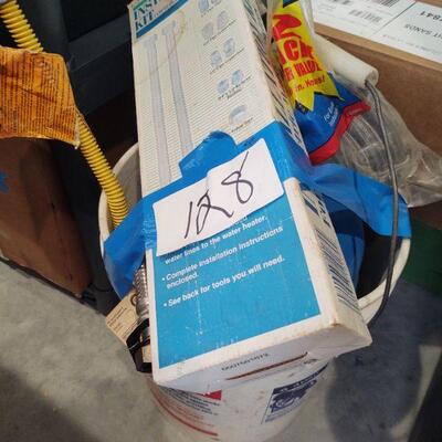 lot 128 -Bucket of assorted plumbing tubing, water heater installation kit etc.