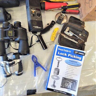 lot 231 - Green backpack, binoculars, flashlights, pancho, night vision scope, gloves, pocket knives, lock picking book/set, etc.