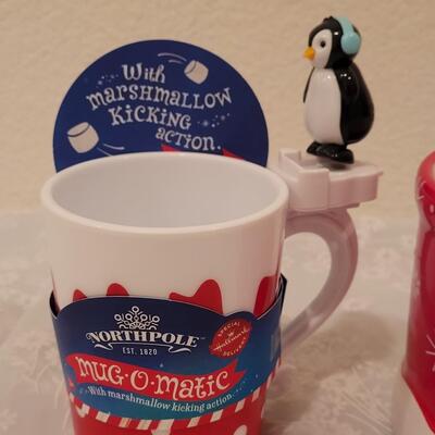 Lot 195: Christmas Coca-Cola Coffee Cup and Marshmallow Kicking Penguin Hot Cocoa Mug