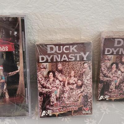 Lot 341: Duck Dynasty CD, Playing Cards and God Bless Photo Visor Clip