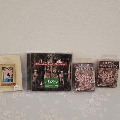 Lot 341: Duck Dynasty CD, Playing Cards and God Bless Photo Visor Clip
