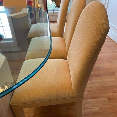 Fabulous glass and marble dining table with freshly upholstered pale yellow chairs