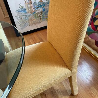 Fabulous glass and marble dining table with freshly upholstered pale yellow chairs