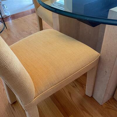 Fabulous glass and marble dining table with freshly upholstered pale yellow chairs