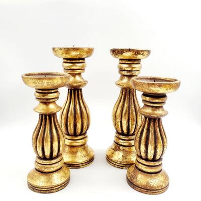 GOLD COLORED PILLAR CANDLE HOLDERS SET OF 4