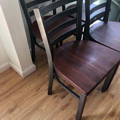 Four vintage heavy metal and wood chairs