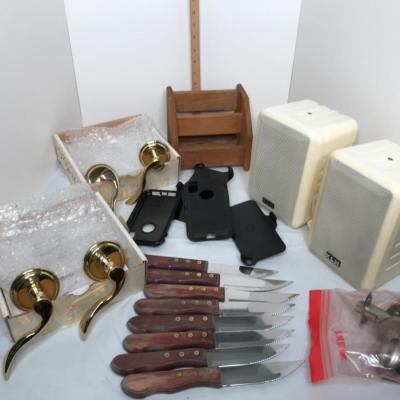 2 speakers,door knobs, 8 steak knives,4 phone cases,2 brass door knobs, caddy for remotes