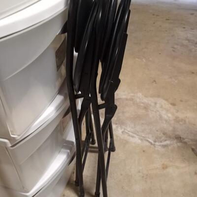 2 black small folding chairs