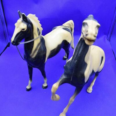 2 white and black horse w/ chain
