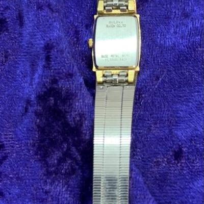 LOT:17: Bulova Gold tone Stainless Steel Black face Quartz Watch