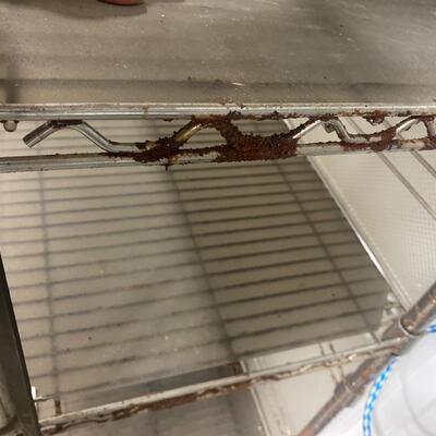 S88 Metal shelving on wheels, 75 and three-quarter inches tall, 18 inches deep, 47 1/2 inches wide. Has rust