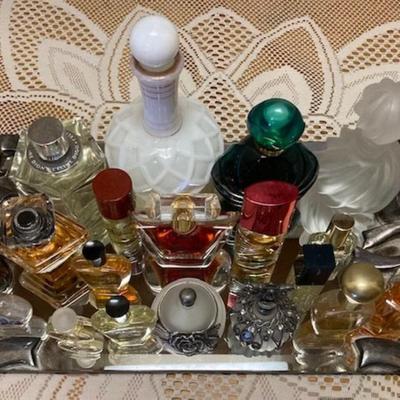 Perfume And Perfume Bottles On Mirrored Tray