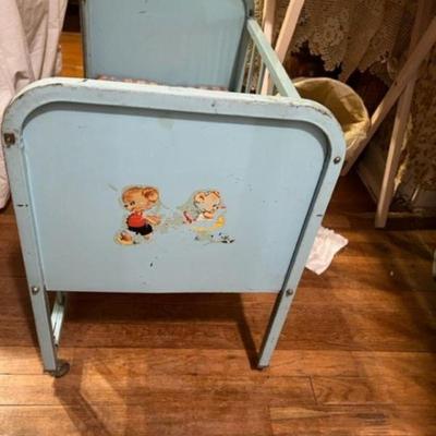 Amsco Doll crib foot board view with baby bear decals and wooden wheels