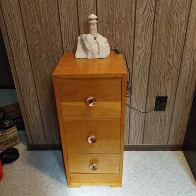 WOODEN  THREE DRAWER CABINET AND STONE LIGHTHOUSE LIGHT