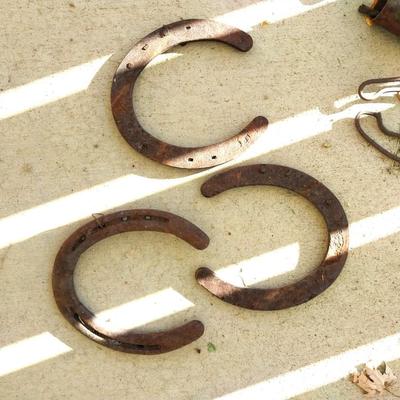 RUSTIC BELLS HUNG FROM VARIETY OF SHAPES AND HORSESHOES