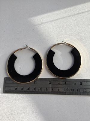 Gold tone and black hoop earrings