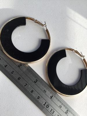 Gold tone and black hoop earrings