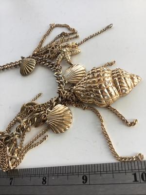 Gold tone charm sea necklace
