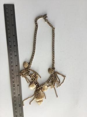 Gold tone charm sea necklace
