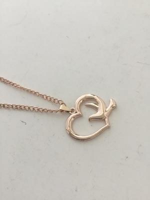 Gold tone bird and heart necklace