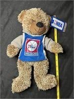 Philadelphia 76ers plush teddy bear wearing a team jersey, featuring original NBA hangtag and measured with a yellow ruler.
