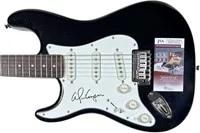 Black electric guitar signed on the white pickguard by Alice Cooper, accompanied by a JSA certificate of authenticity.