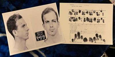 Reproduction prints of Lee Harvey Oswald's Dallas Police Department mugshot and fingerprint card, dated November 23, 1963.