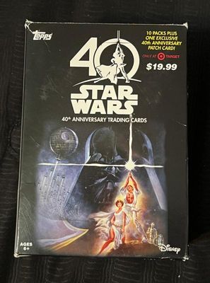 Topps Star Wars 40th Anniversary trading card box, featuring classic poster artwork and containing ten packs plus an exclusive patch card.