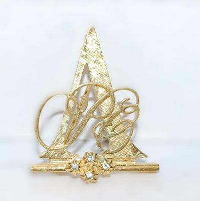 Gold Colored TRIANGLE BROOCH (1¼" x 1¼") with a Script Design and 4 Accent Stones on a Gold Tone Setting