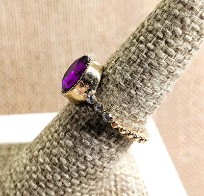 **New Arrival** Size 6¾ Oval PURPLE Stone "Cupped" RING with 3 Small Clear Stones Each Side Accents on a Thin Swirl Gold Tone...