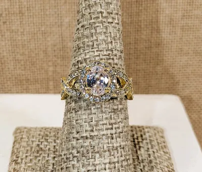 **New Arrival** Size 7¾ Ornate Bejeweled Clear Oval Main Stone RING with Side Loop Accents and Interesting Looped Gold Tone Setting &...