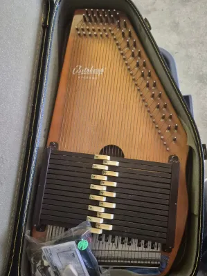 Sale Photo Thumbnail #289: Autoharp OS15B This 15-chord autoharp plays in seven different keys. The traditional button configuration makes it easy to learn and to continue to play for years to come. This is one of our most popular models. Good condition, all additional parts and in