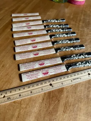 Sale Photo Thumbnail #174: .Beautiful set of 10 vintage mid-century modern steak knives made by Carvel Hall (Briddell). These feature a gorgeous, detailed metal floral overlay pattern on the handles.

Excellent vintage condition with minimal wear. 2 knives show small wear on the ha
