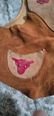 Sale Photo Thumbnail #292: Keyston Bros. "Lasso 'Em Bill" kids suede leather vest
> steer & flower applique still original
> suede in great shape....ready for the next cow kid !
> minor stitch repair under arm
> Size: 10" shoulders / 15" body / 14" height