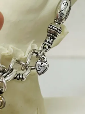 Sale Photo Thumbnail #393: Share the love with this Brighton silver-tone heart jewelry collection featuring a bracelet, a matching pair of heart stud earrings, and a single coordinating heart drop earring with gold-tone heart accents
Complete set:  4 pcs
