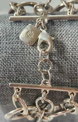 Sale Photo Thumbnail #411: RALPH LAUREN Signed Silver Stine 3 Strand Large Link Bracelet 6.25" & hinged Stainless Choker & 925 Onyx Ring
> hinged steel Choker in excellent condition, hing works effortlessly
> Ring is marked sterling and Navajo maker mark with arrow.....Size 8
Wonde