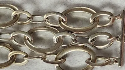 Sale Photo Thumbnail #412: RALPH LAUREN Signed Silver Stine 3 Strand Large Link Bracelet 6.25" & hinged Stainless Choker & 925 Onyx Ring
> hinged steel Choker in excellent condition, hing works effortlessly
> Ring is marked sterling and Navajo maker mark with arrow.....Size 8
Wonde