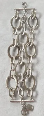 Sale Photo Thumbnail #414: RALPH LAUREN Signed Silver Stine 3 Strand Large Link Bracelet 6.25" & hinged Stainless Choker & 925 Onyx Ring
> hinged steel Choker in excellent condition, hing works effortlessly
> Ring is marked sterling and Navajo maker mark with arrow.....Size 8
Wonde