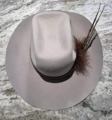 Sale Photo Thumbnail #171: Dynafelft water proof "Stetson Hat" ~ size 7.25
Band and feather are a "yahoo"
Water repellent fur blend is most likely made of wool and rabbit fur blend.
Dynafelft know for top quality line of hats.
There is no sweat on interior, no damage, a small gray 