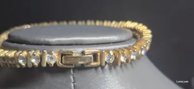 Sale Photo Thumbnail #191: Vintage gold tone Tennis Bracelet ~ Cz stones & MCM design
> each stone is housed in a square bumper bracelet [bar set]
> round stones give a continuous line of clear faceted CZ stones
> excellent condition / snap clasp  / 7.5" long