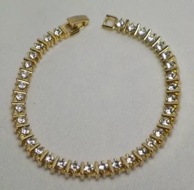 Sale Photo Thumbnail #189: Vintage gold tone Tennis Bracelet ~ Cz stones & MCM design
> each stone is housed in a square bumper bracelet [bar set]
> round stones give a continuous line of clear faceted CZ stones
> excellent condition / snap clasp  / 7.5" long