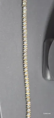 Sale Photo Thumbnail #195: Vintage gold tone Tennis Bracelet ~ Cz stones & MCM design
> each stone is housed in a square bumper bracelet [bar set]
> round stones give a continuous line of clear faceted CZ stones
> excellent condition / snap clasp  / 7.5" long