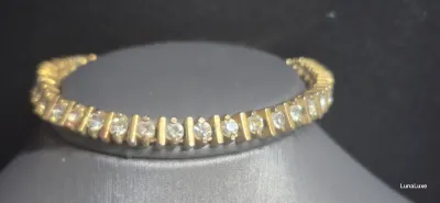 Sale Photo Thumbnail #193: Vintage gold tone Tennis Bracelet ~ Cz stones & MCM design
> each stone is housed in a square bumper bracelet [bar set]
> round stones give a continuous line of clear faceted CZ stones
> excellent condition / snap clasp  / 7.5" long